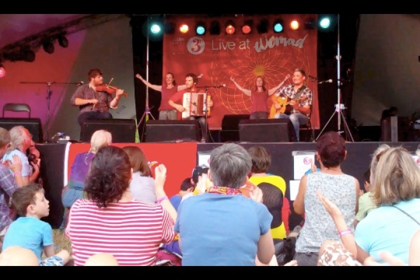 Barrule and dancers onstage at WOMAD